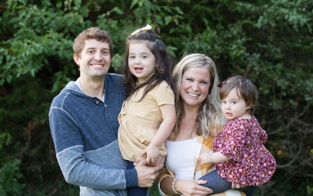 a family of four smiling at the camera